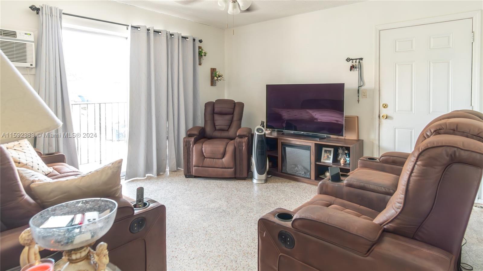 23 West 13th Street Hialeah, FL 33010 - Photo 45 of 54 a living room with furniture and a flat screen tv