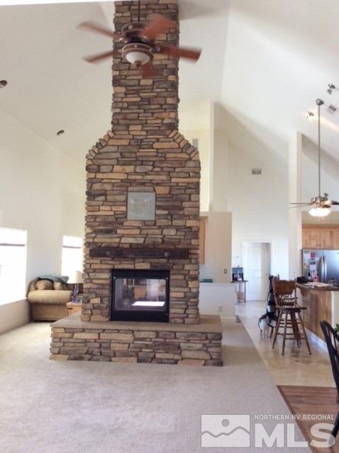 3950 Schindler Road Fallon, NV 89406 - Photo 13 of 24 a living room with furniture a table and a fireplace