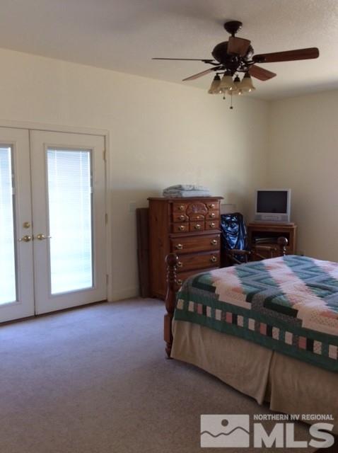 3950 Schindler Road Fallon, NV 89406 - Photo 23 of 24 a bedroom with a bed and a chandelier
