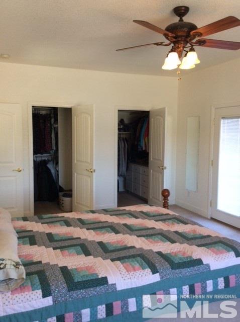 3950 Schindler Road Fallon, NV 89406 - Photo 24 of 24 a bedroom with a bed and a chandelier
