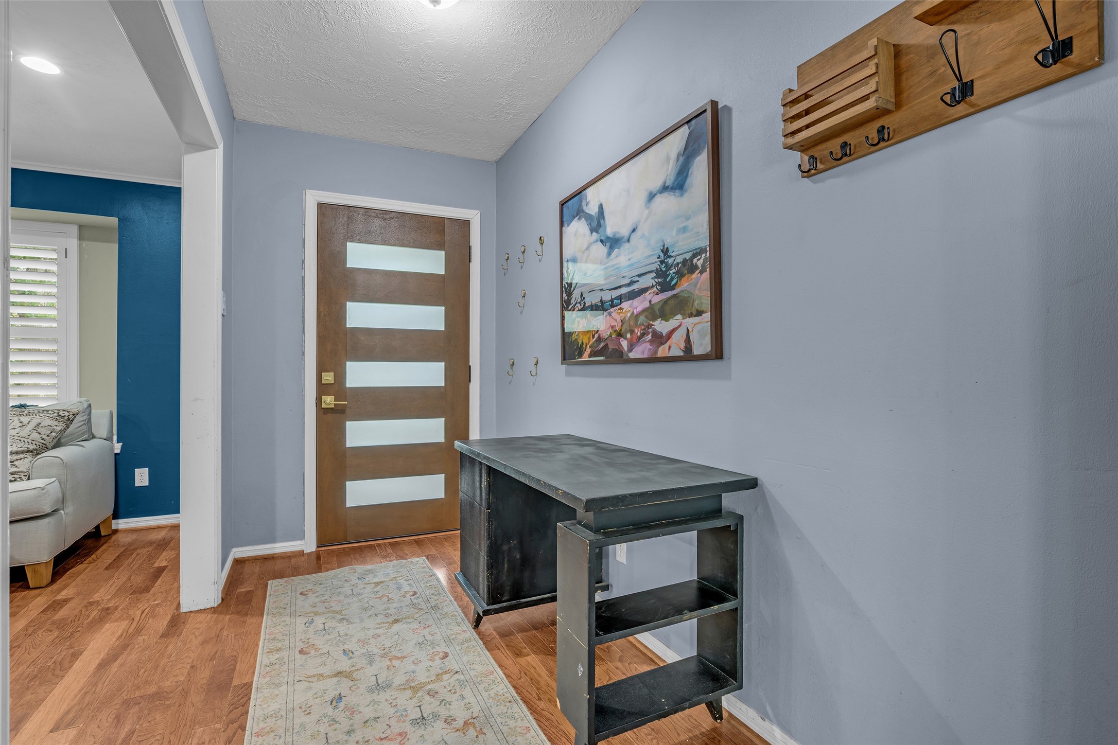 947 Thornton Road Houston, TX 77018 - Photo 5 of 34 Inviting entryway with a modern door and hardwood floors.