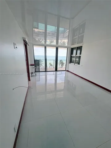 a view of an empty room with glass door