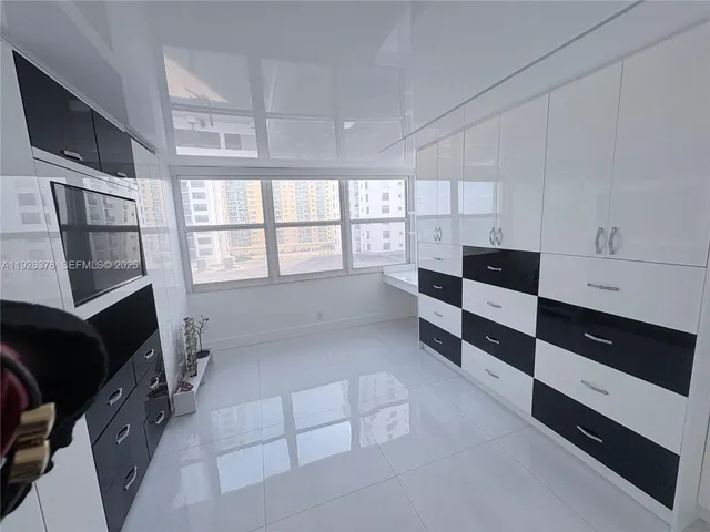 a kitchen with stainless steel appliances kitchen island granite countertop a stove a microwave and a refrigerator