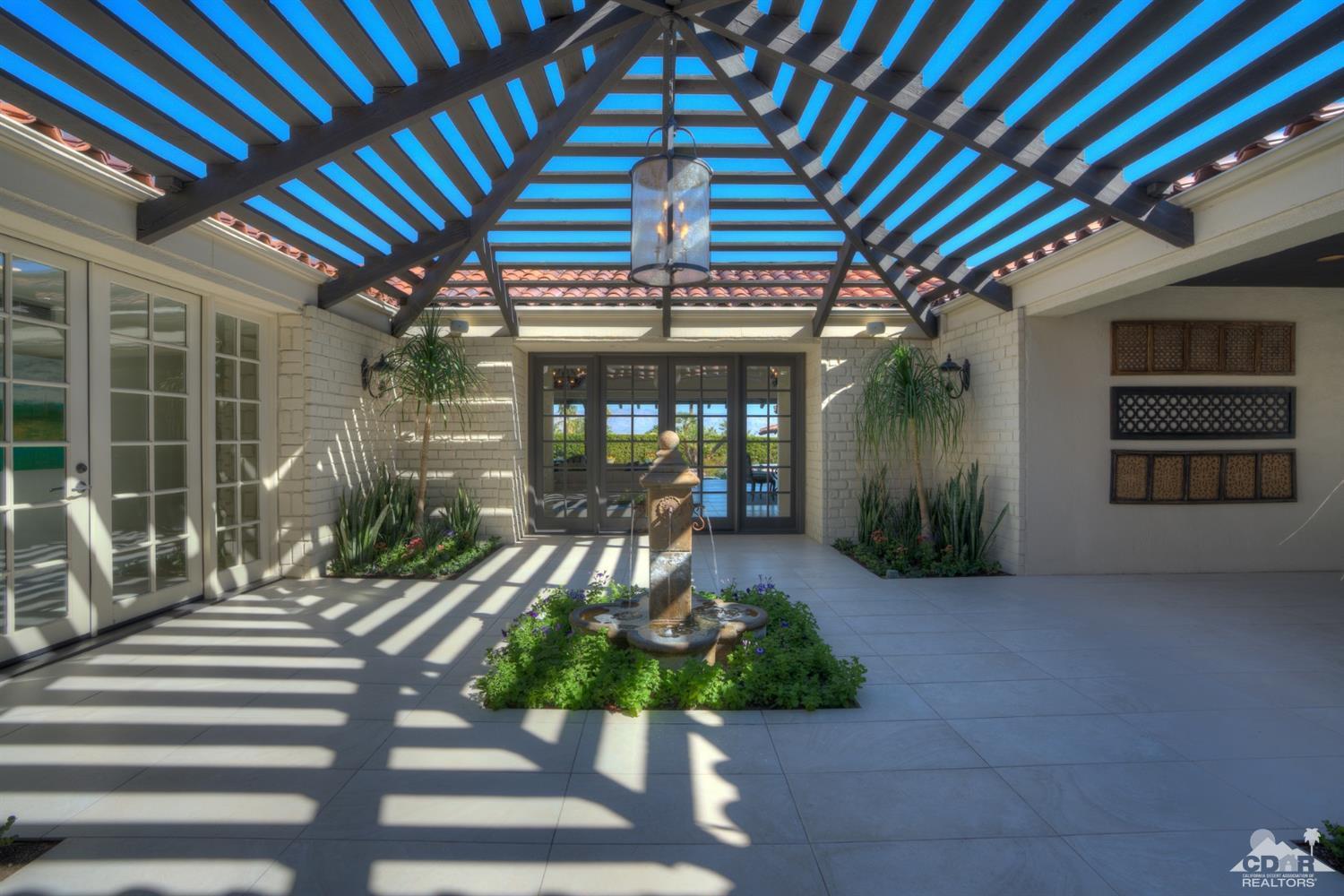 40757 Thunderbird Road Rancho Mirage, CA 92270 - Photo 19 of 70 a view of a porch with furniture and floor to ceiling window
