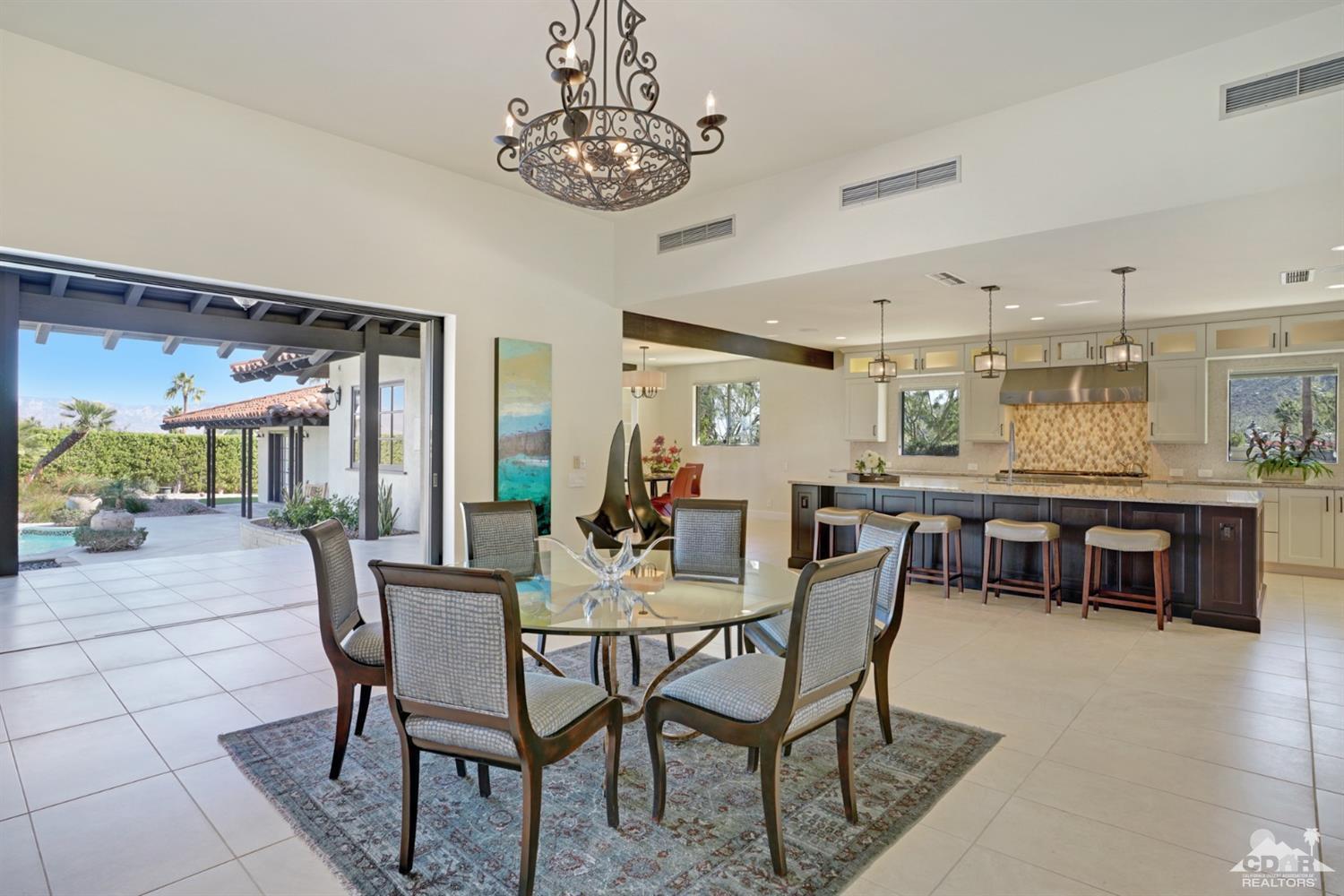 40757 Thunderbird Road Rancho Mirage, CA 92270 - Photo 27 of 70 a dining room with furniture a chandelier and window
