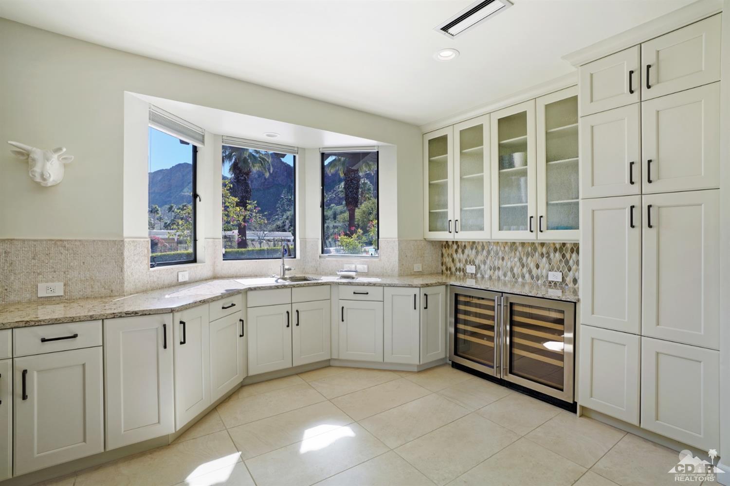 40757 Thunderbird Road Rancho Mirage, CA 92270 - Photo 32 of 70 a kitchen with granite countertop a sink and cabinets