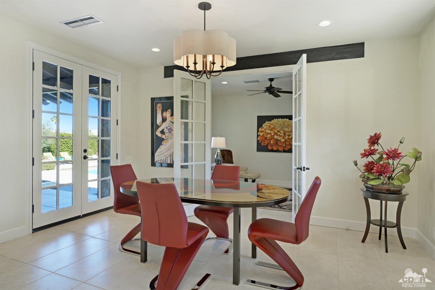 40757 Thunderbird Road Rancho Mirage, CA 92270 - Photo 34 of 70 a view of a dining room with furniture a chandelier and wooden floor