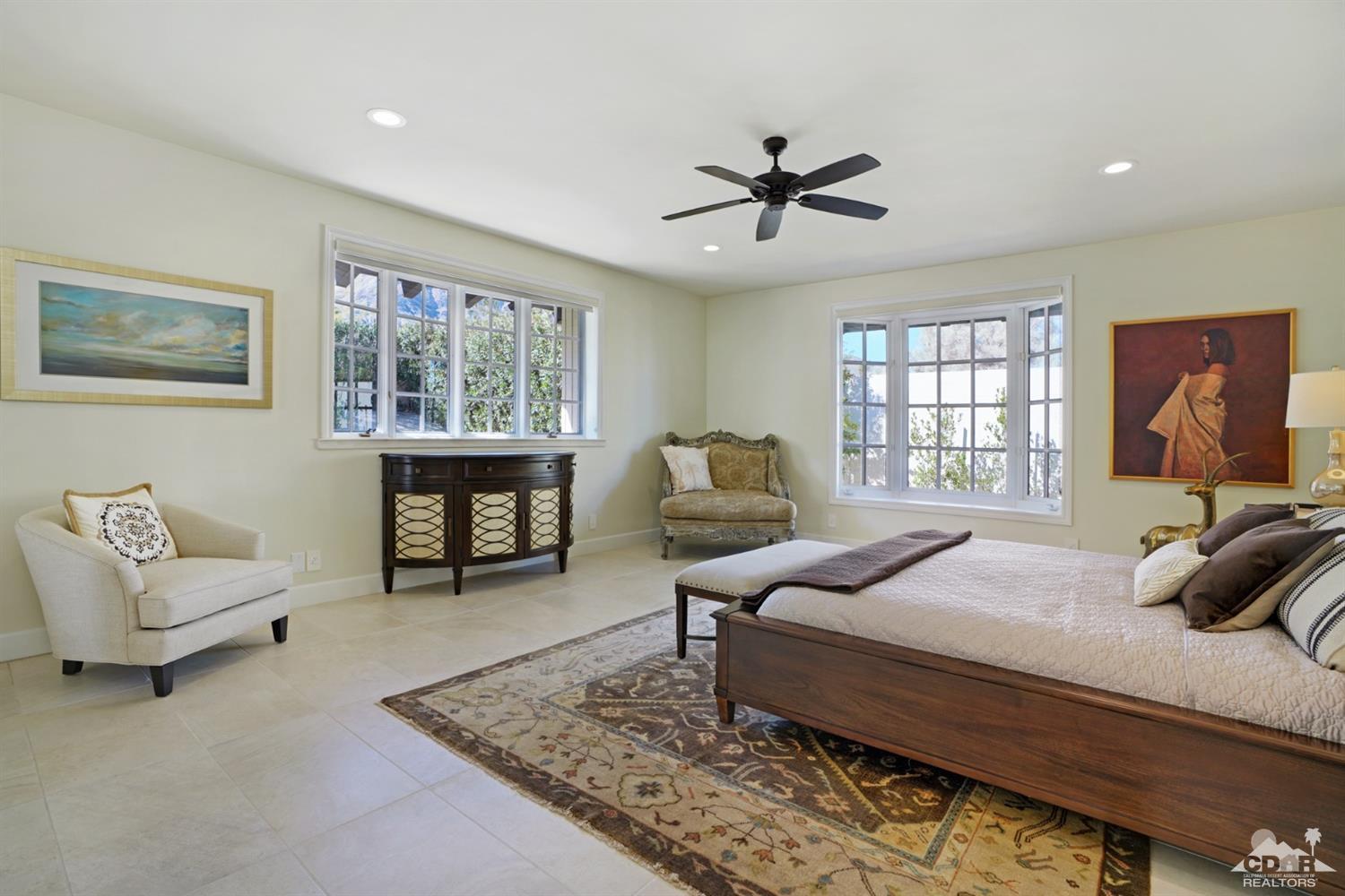 40757 Thunderbird Road Rancho Mirage, CA 92270 - Photo 43 of 70 a spacious bedroom with a bed a couch and a window