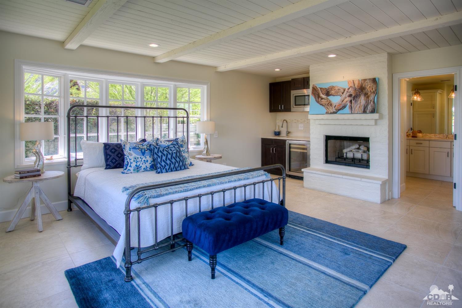 40757 Thunderbird Road Rancho Mirage, CA 92270 - Photo 47 of 70 a bedroom with a bed a fireplace and a window