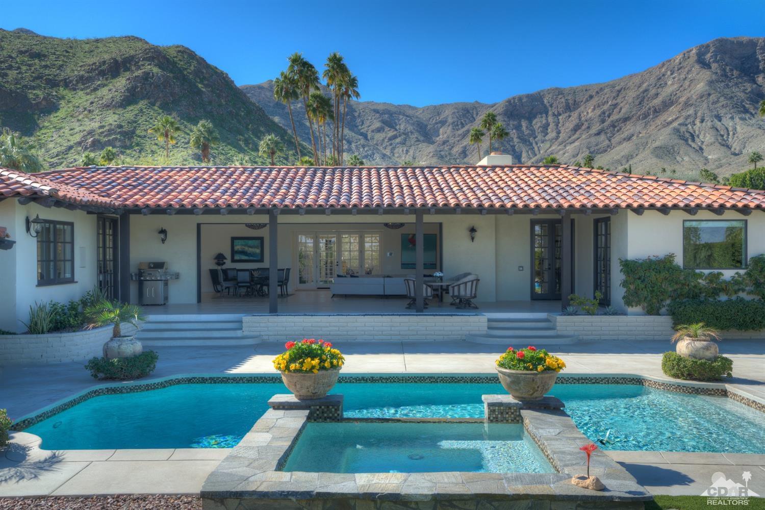 40757 Thunderbird Road Rancho Mirage, CA 92270 - Photo 56 of 70 a front view of a house with swimming pool table and chairs