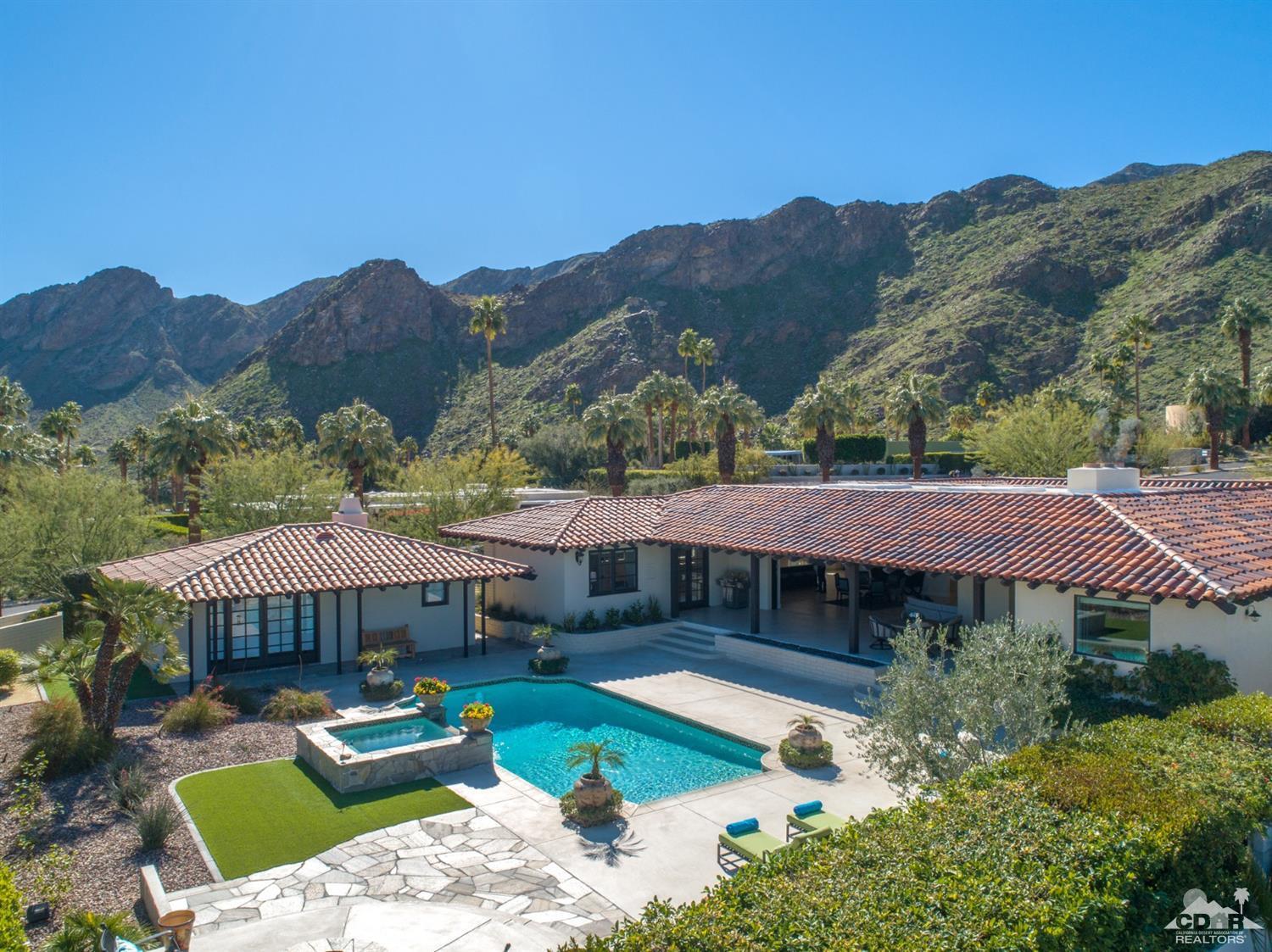 40757 Thunderbird Road Rancho Mirage, CA 92270 - Photo 66 of 70 a view of a house with pool and a chairs under an umbrella