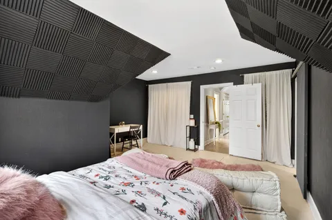 a bedroom with a bed and a dresser