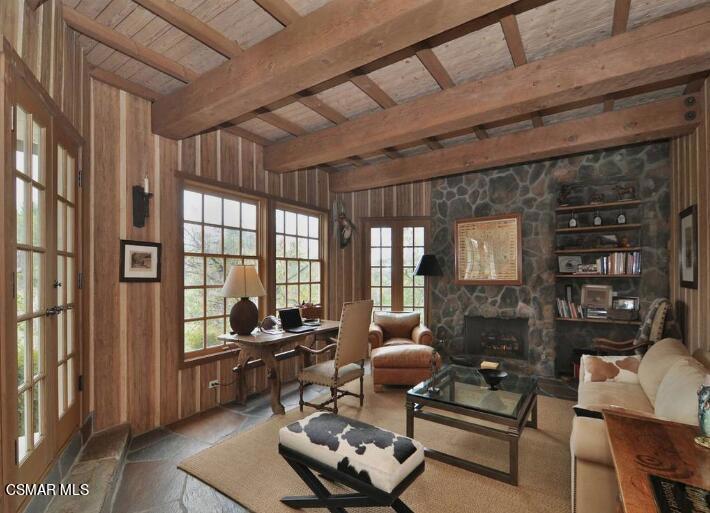 5537 Round Meadow Road Hidden Hills, CA 91302 - Photo 12 of 17 a living room with furniture a rug a fireplace and a large window