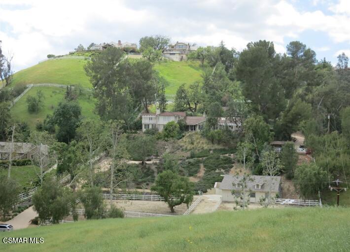 5537 Round Meadow Road Hidden Hills, CA 91302 - Photo 3 of 17 a view of a garden with a building in the background