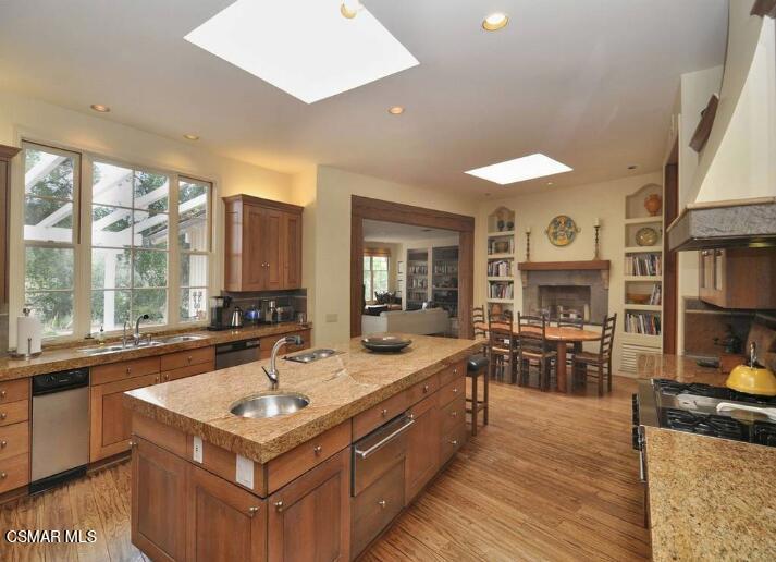 5537 Round Meadow Road Hidden Hills, CA 91302 - Photo 6 of 17 a large kitchen with stainless steel appliances granite countertop a sink and a stove