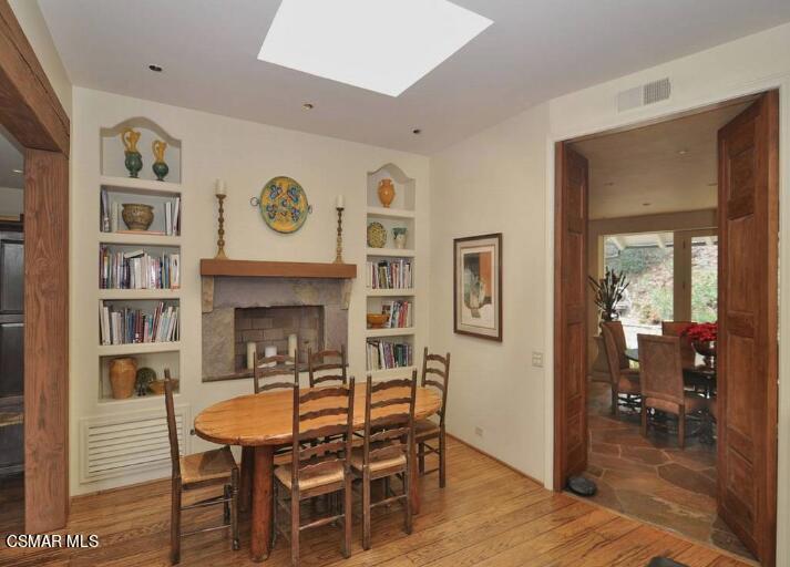 5537 Round Meadow Road Hidden Hills, CA 91302 - Photo 8 of 17 a dining room with furniture and wooden floor
