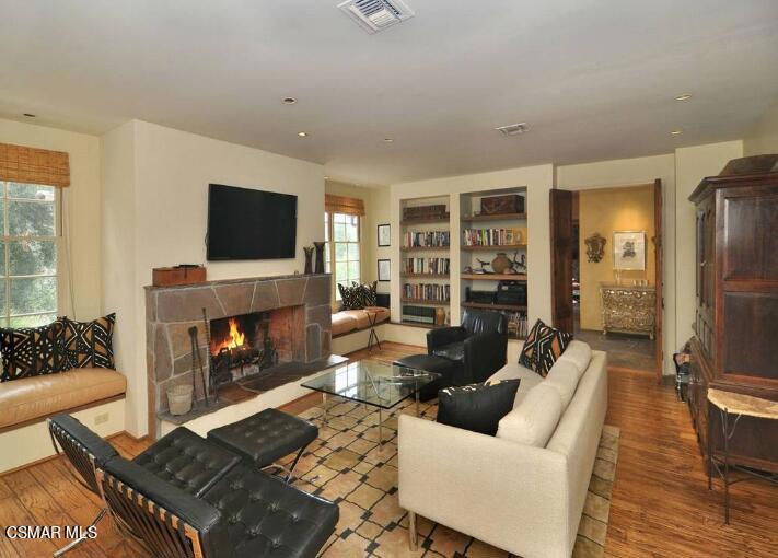 5537 Round Meadow Road Hidden Hills, CA 91302 - Photo 9 of 17 a living room with furniture and a fireplace