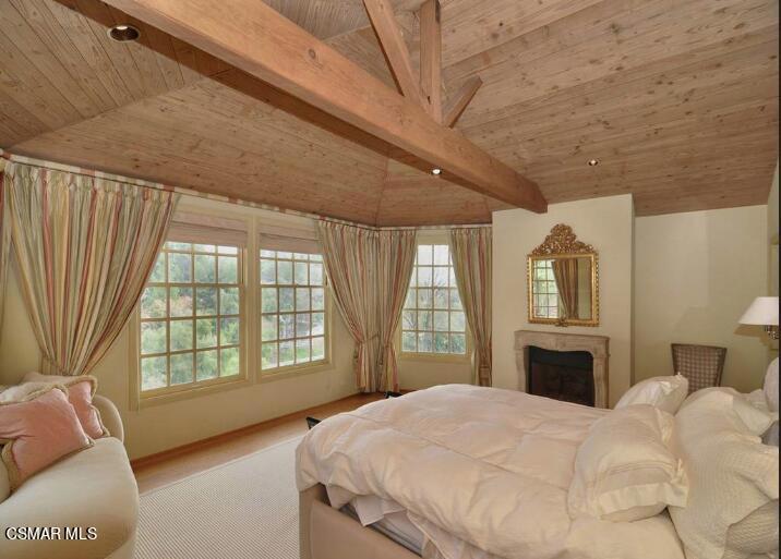 5537 Round Meadow Road Hidden Hills, CA 91302 - Photo 10 of 17 a bedroom with a bed dresser and a large window