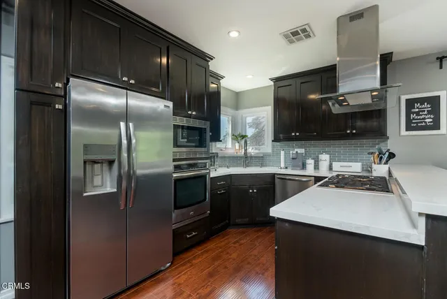 a kitchen with a sink stove and microwave
