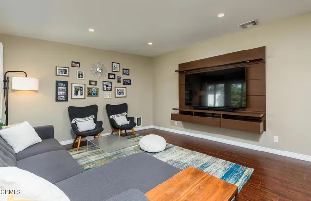 a bedroom with a bed wooden floor and window
