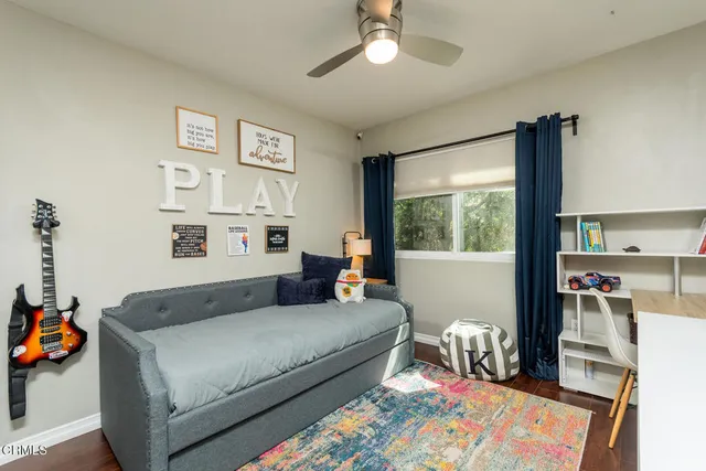 a bedroom with furniture and a window