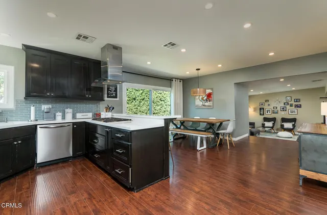 a kitchen with cabinets a sink and stainless steel appliances