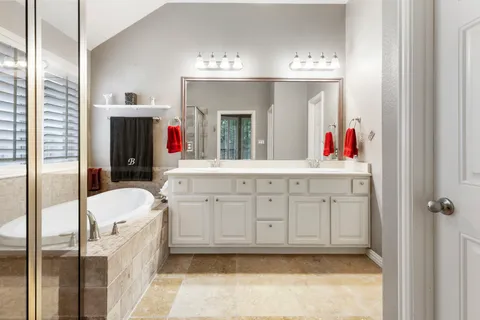 a bathroom with a sink vanity and mirror