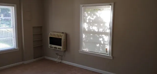 a room with window and a flat screen tv