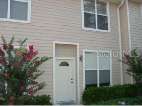 a view of a house with potted plants