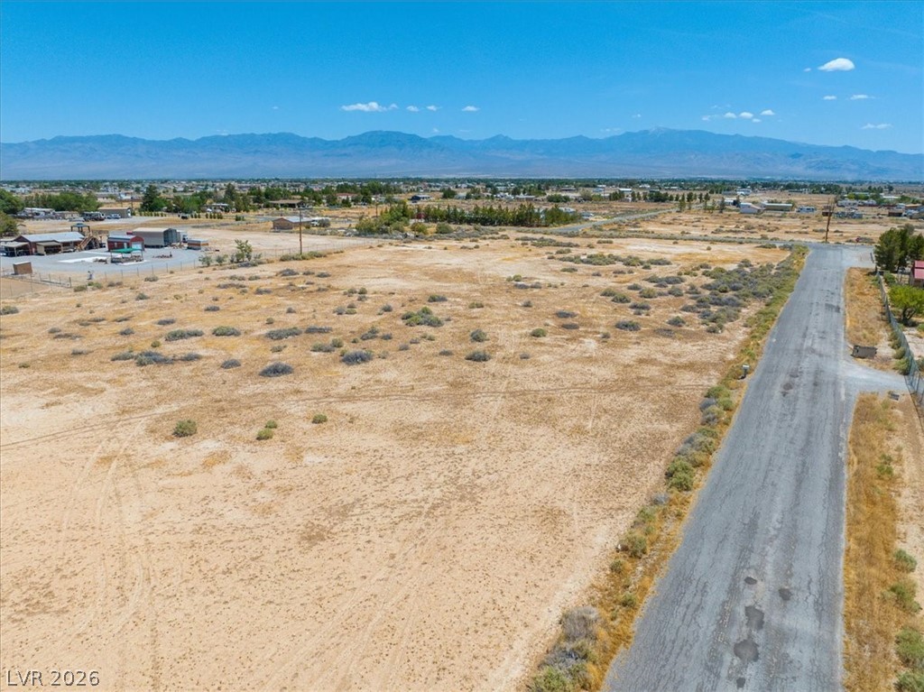 4580 Lawrence Road Pahrump, NV 89048 - Photo 2 of 40 A vast, undeveloped parcel of land with a distant mountain backdrop, ready for your vision.