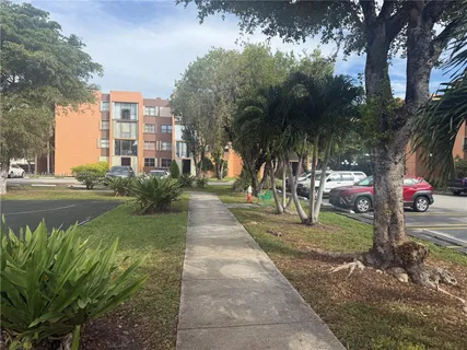 a view of yard with swimming pool and trees