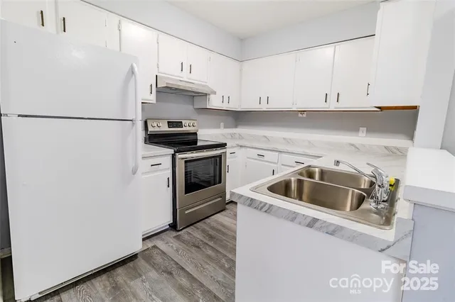a kitchen with a sink and a refrigerator