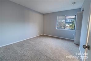 4814 Spring Lake Drive, Unit E Charlotte, NC 28212 - Photo 7 of 15 an empty room with windows