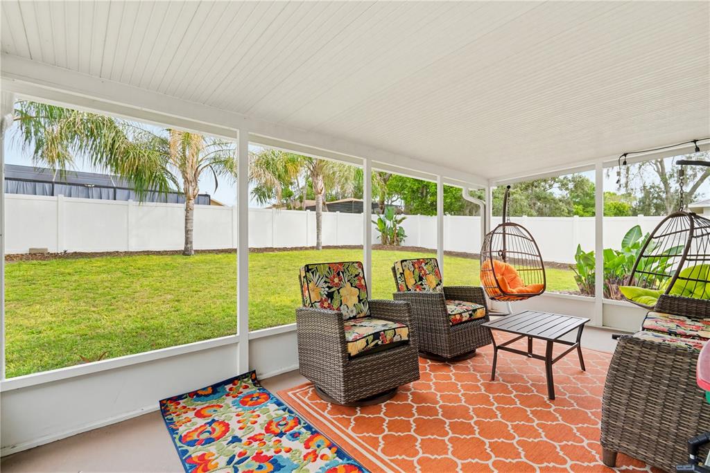 3497 Chadwick Avenue Spring Hill, FL 34609 - Photo 35 of 47 a living room with furniture and a floor to ceiling window