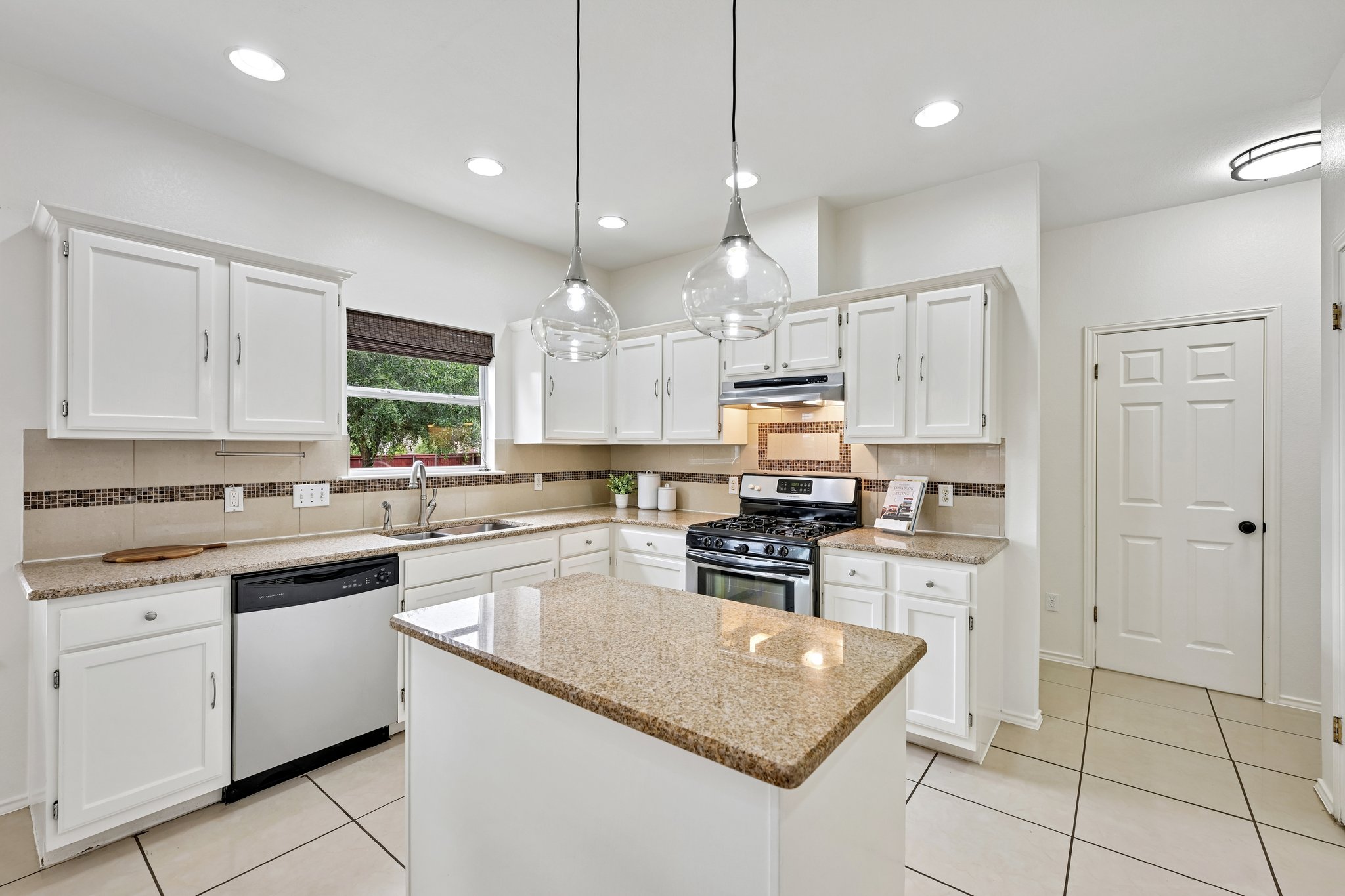 4100 Mocha Trail Austin, TX 78728 - Photo 6 of 33 A well-equipped kitchen awaits culinary adventures with its practical island and contemporary fixtures.