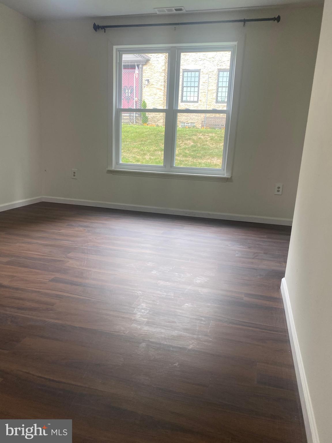 3324 Willits Road, Unit 16A Philadelphia, PA 19136 - Photo 2 of 5 an empty room with wooden floor and windows