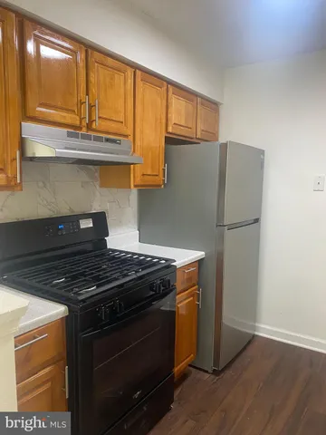 a kitchen with stainless steel appliances granite countertop a stove and a refrigerator