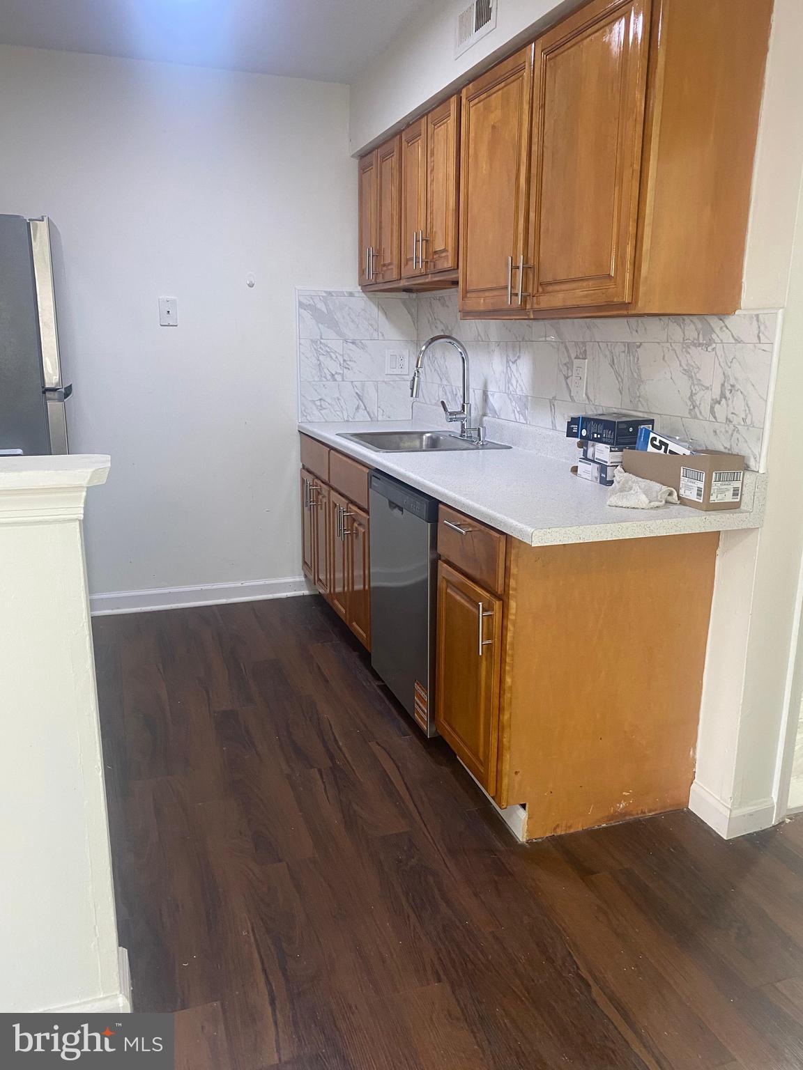 3324 Willits Road, Unit 16A Philadelphia, PA 19136 - Photo 4 of 5 a kitchen with stainless steel appliances granite countertop a sink a stove and a wooden floors
