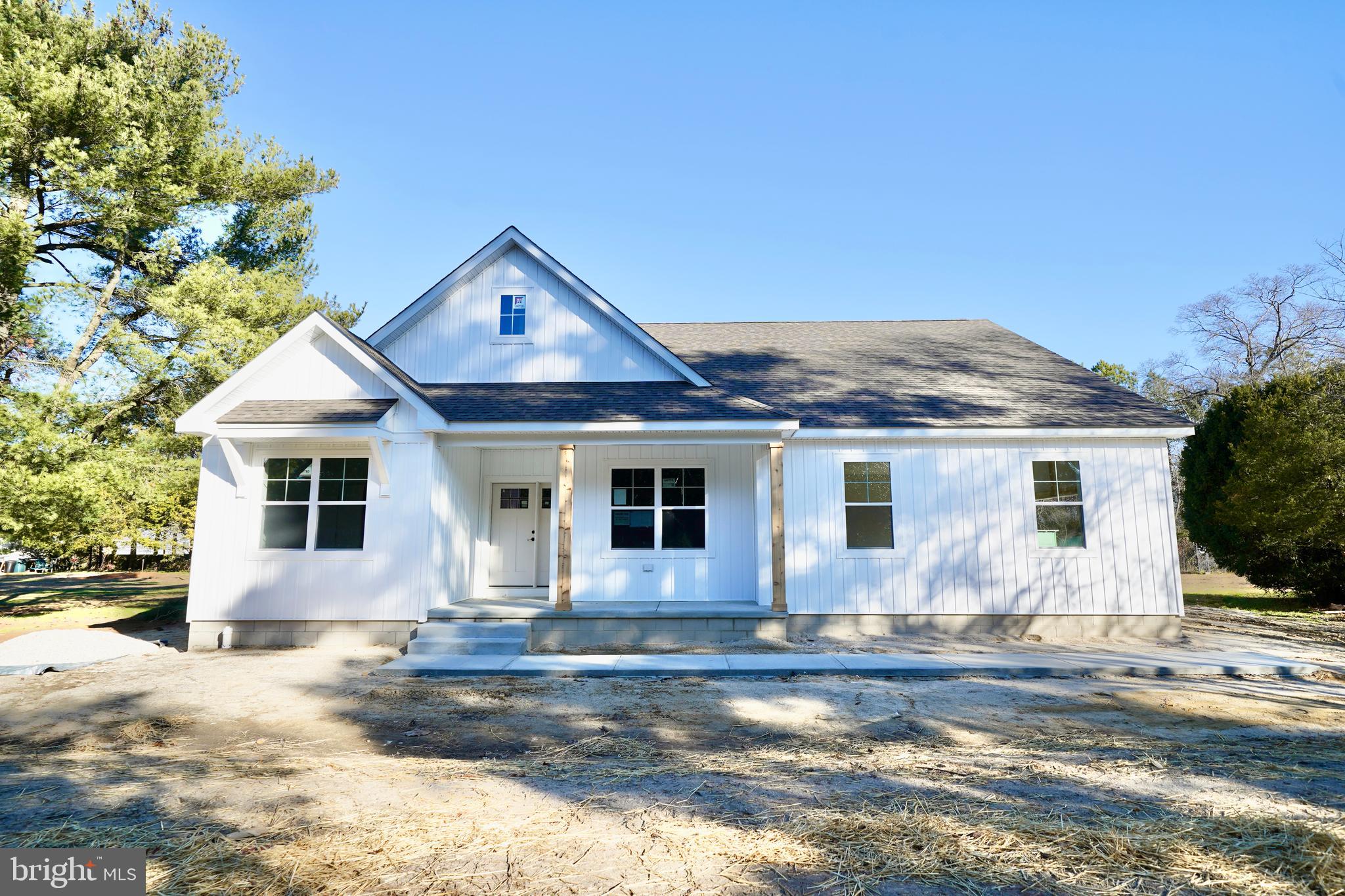 a front view of a house with a yard and seating space
