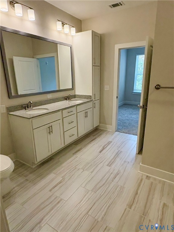 10525 Stony Blf Drive, Unit 205 Ashland, VA 23005 - Photo 7 of 9 a spacious bathroom with a double vanity sink and a mirror