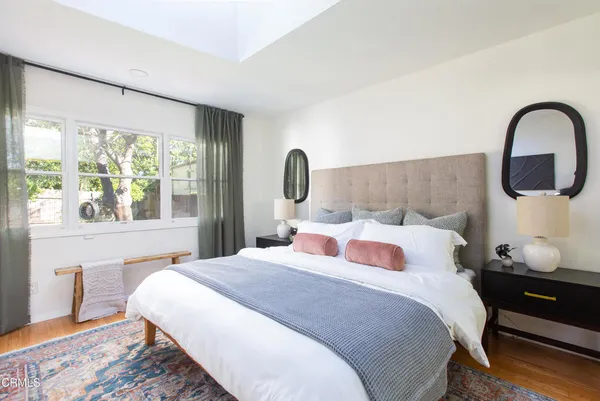 a bedroom with a large bed and a large window