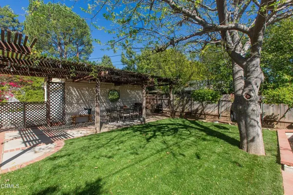 a view of a chair and table in backyard