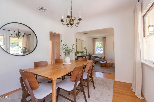 a view of a dining room with furniture and a chandelier
