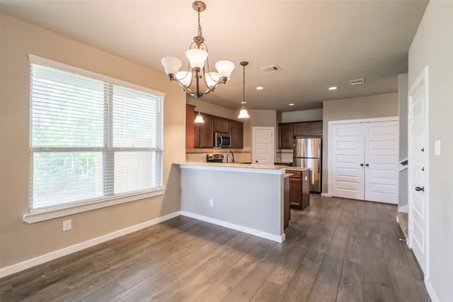 a view of a kitchen with a sink wooden floor and a kitchen
