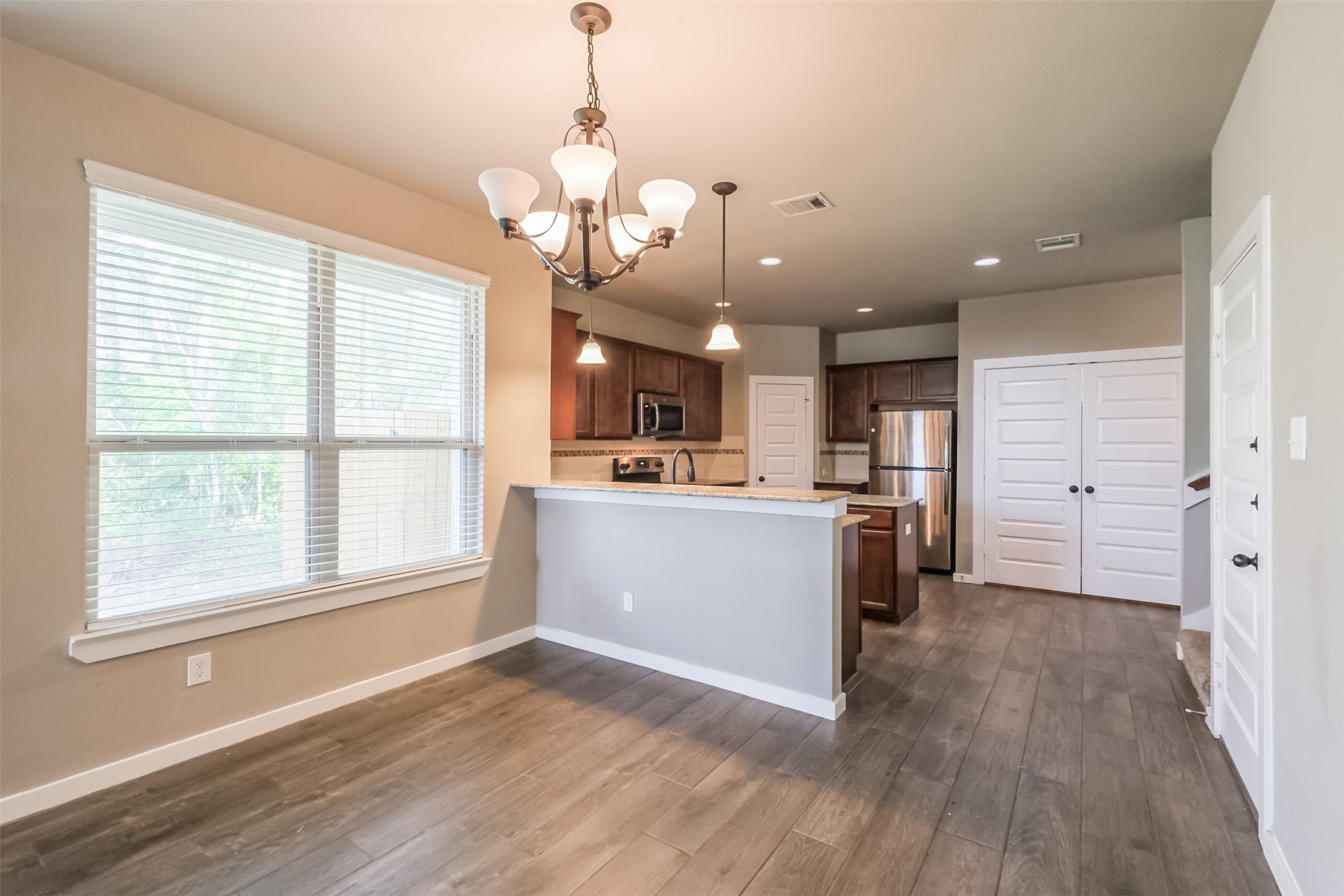 121 Wickersham, Unit A Conroe, TX 77304 - Photo 14 of 37 a view of a kitchen with a sink wooden floor and a kitchen