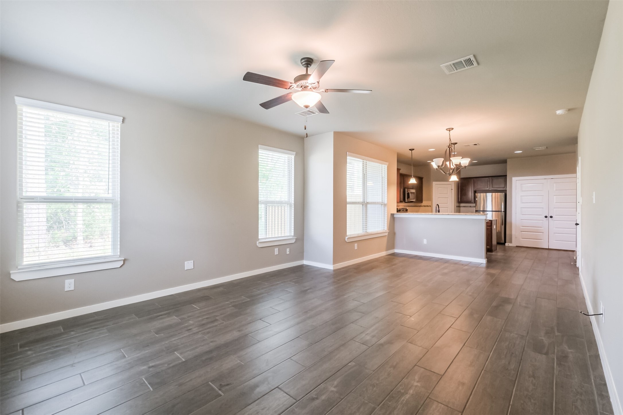 121 Wickersham, Unit A Conroe, TX 77304 - Photo 16 of 37 a view of a livingroom with a ceiling fan window and wooden floor