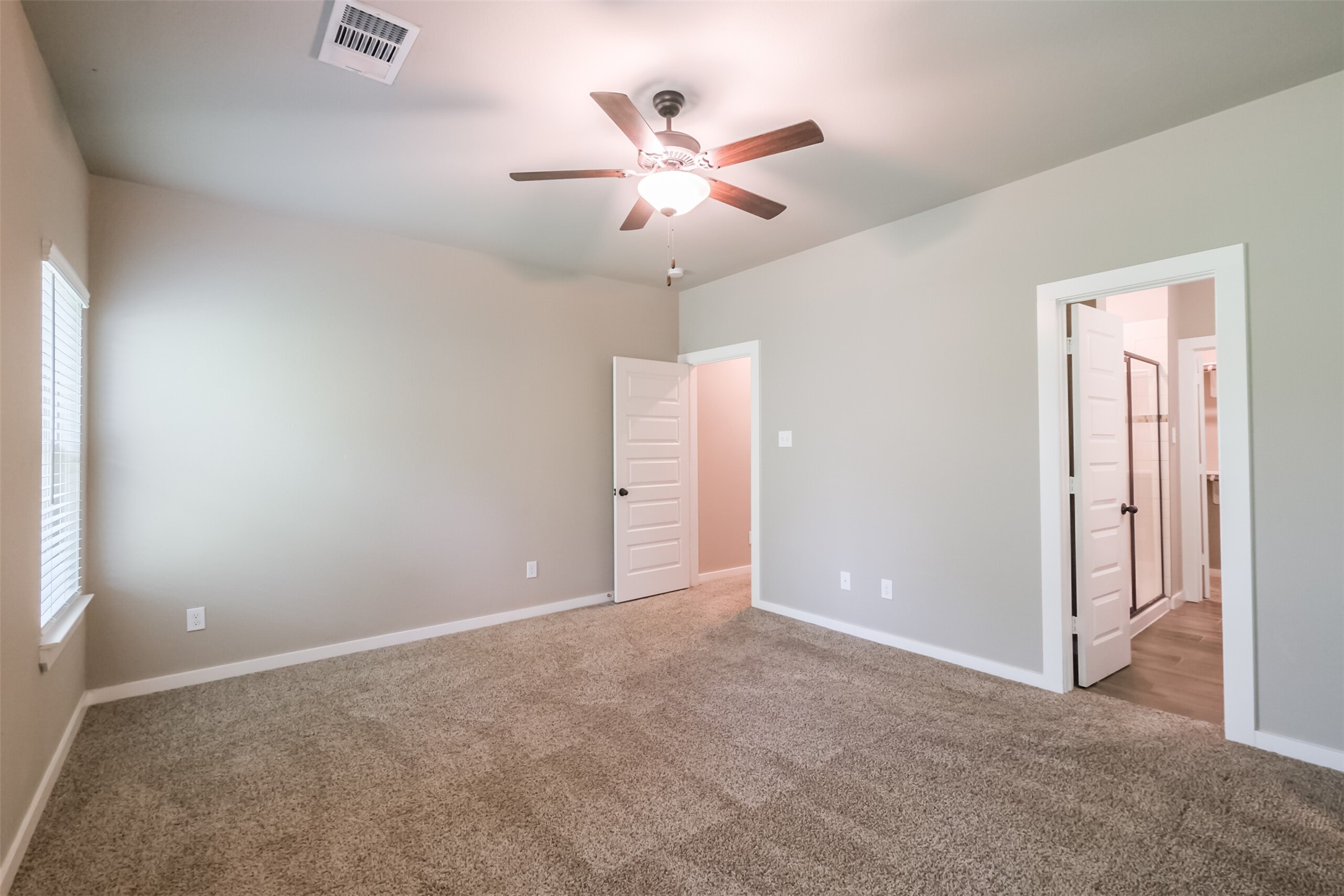 121 Wickersham, Unit A Conroe, TX 77304 - Photo 18 of 37 an empty room with closet and ceiling fan