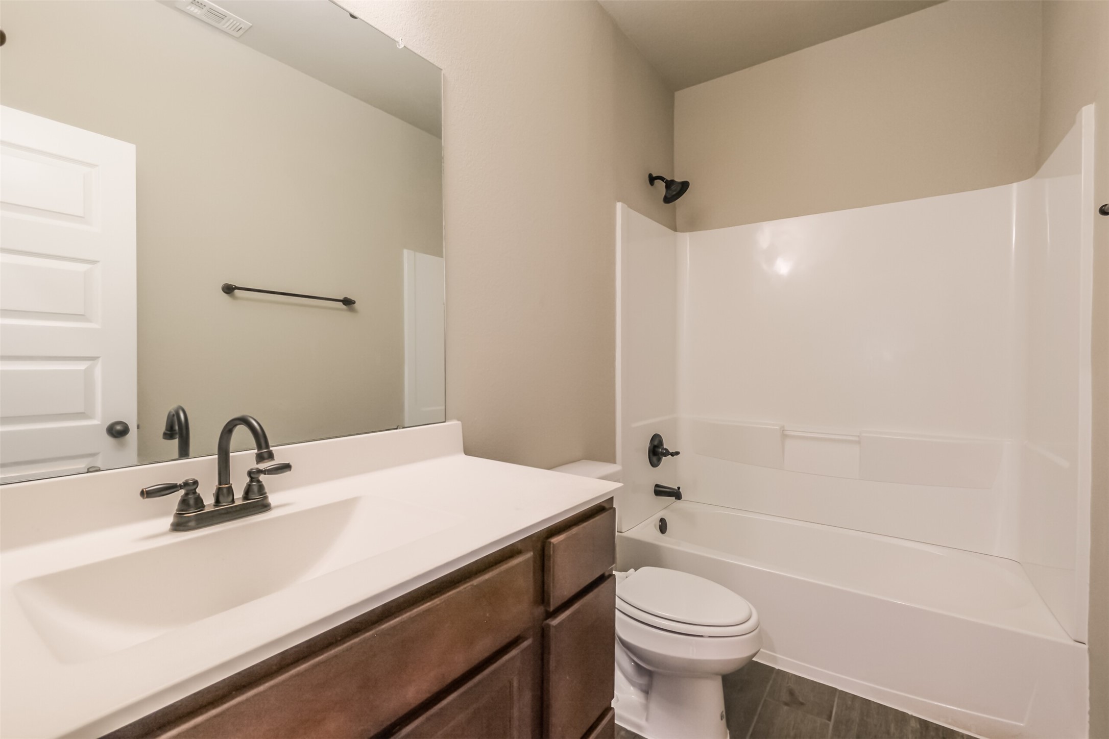 121 Wickersham, Unit A Conroe, TX 77304 - Photo 27 of 37 a bathroom with a sink a toilet and shower