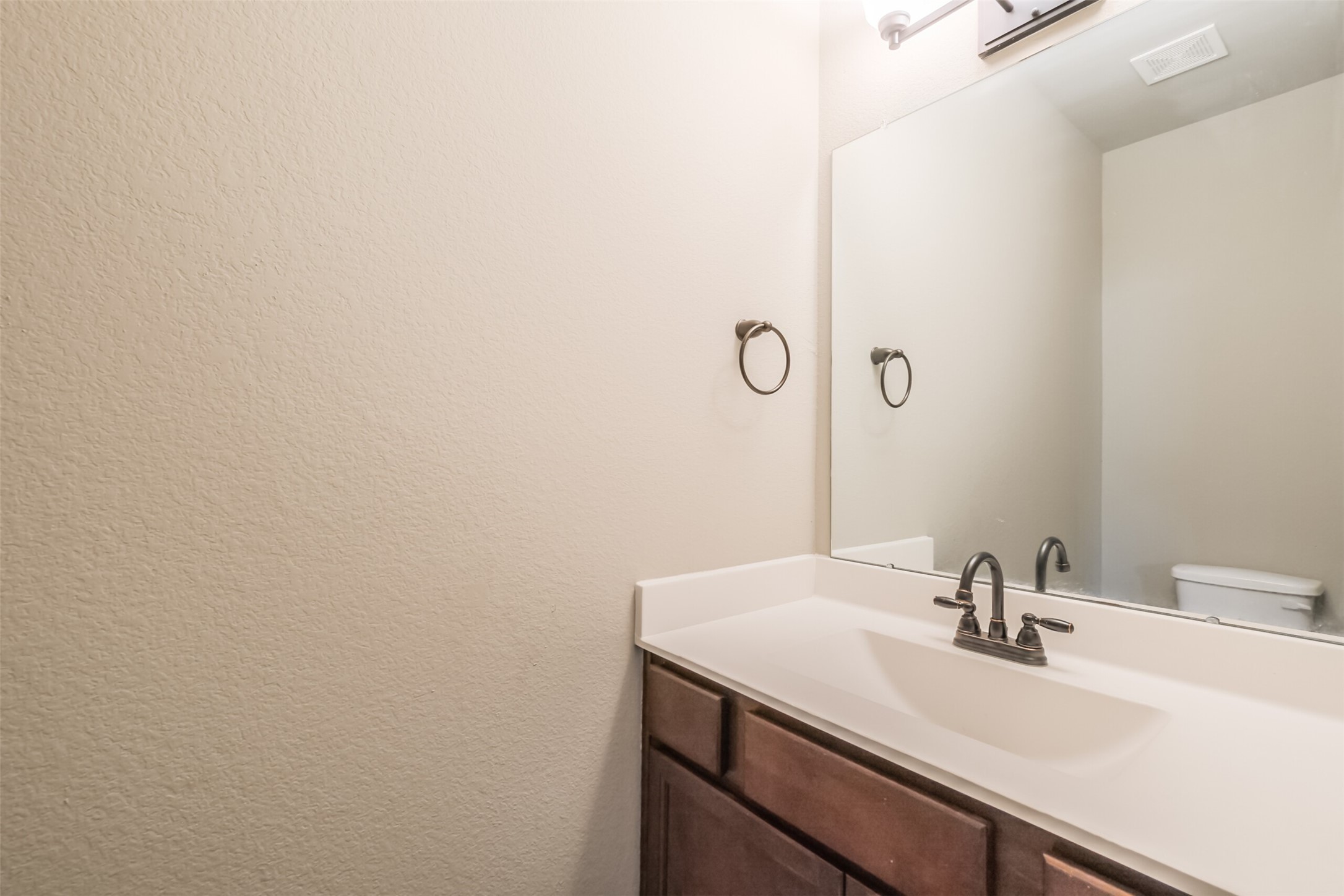 121 Wickersham, Unit A Conroe, TX 77304 - Photo 30 of 37 a bathroom with a sink and a mirror