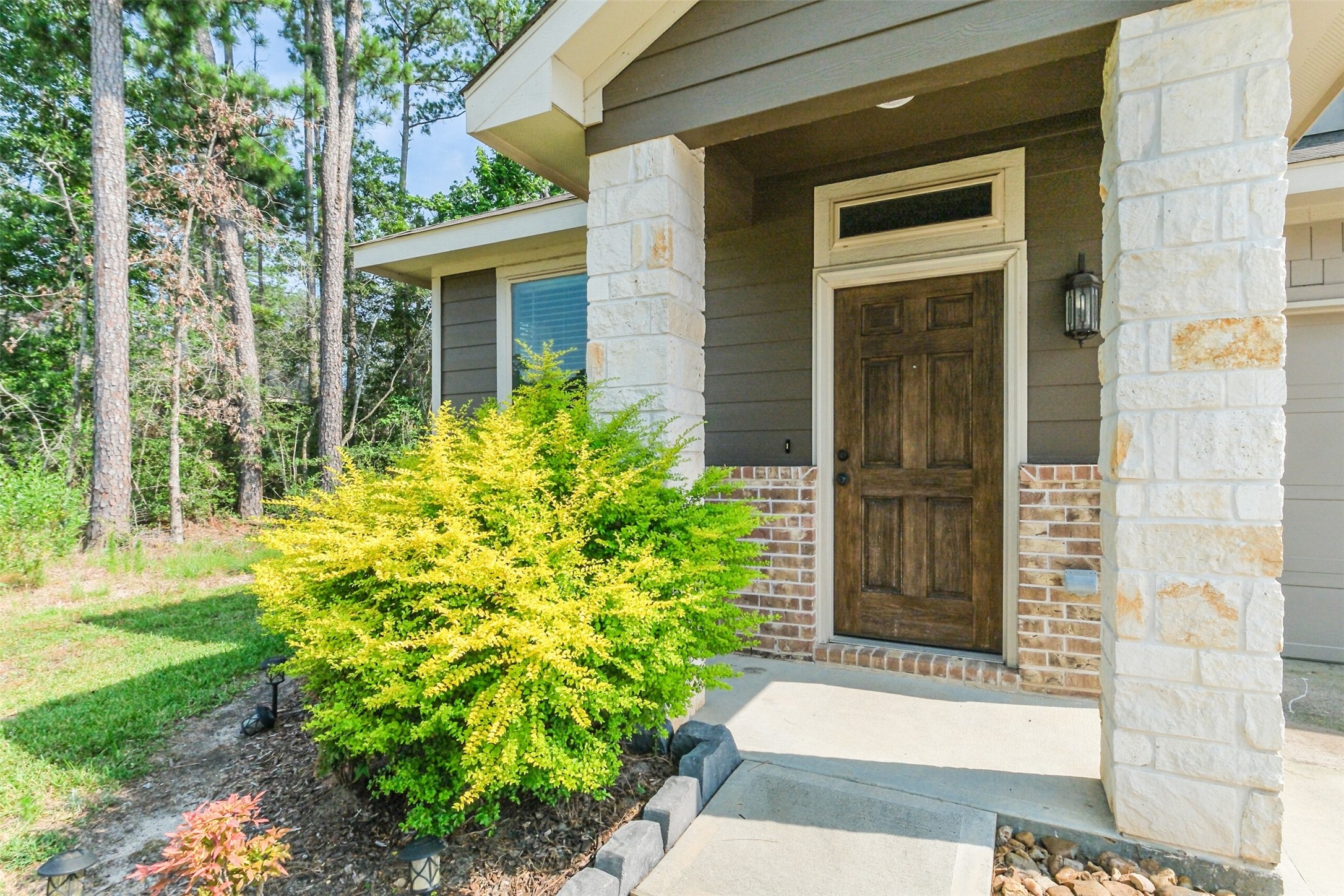 121 Wickersham, Unit A Conroe, TX 77304 - Photo 3 of 37 a front view of a house with a yard